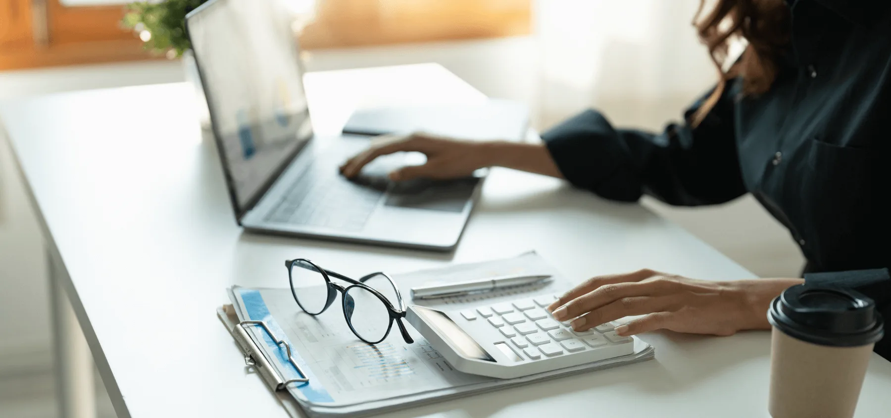 A finance professional reviewing figures at a desk